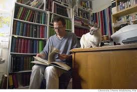 A man, a library, and a cat.  Smells like History to me!